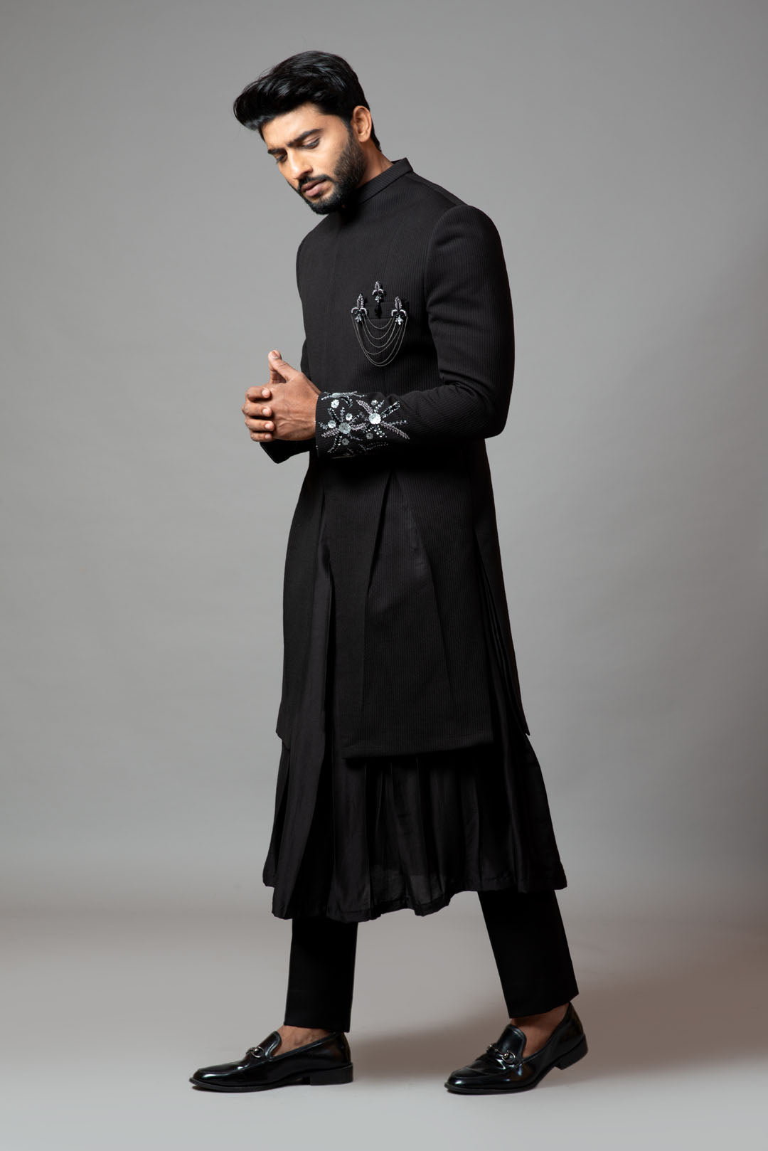 Achkan with slight embroidery on sleeves comes with Anarkali kurta