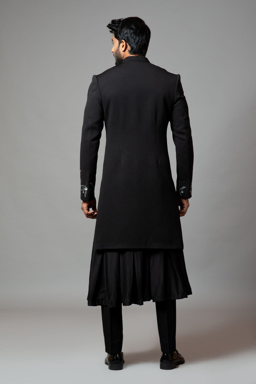 Achkan with slight embroidery on sleeves comes with Anarkali kurta