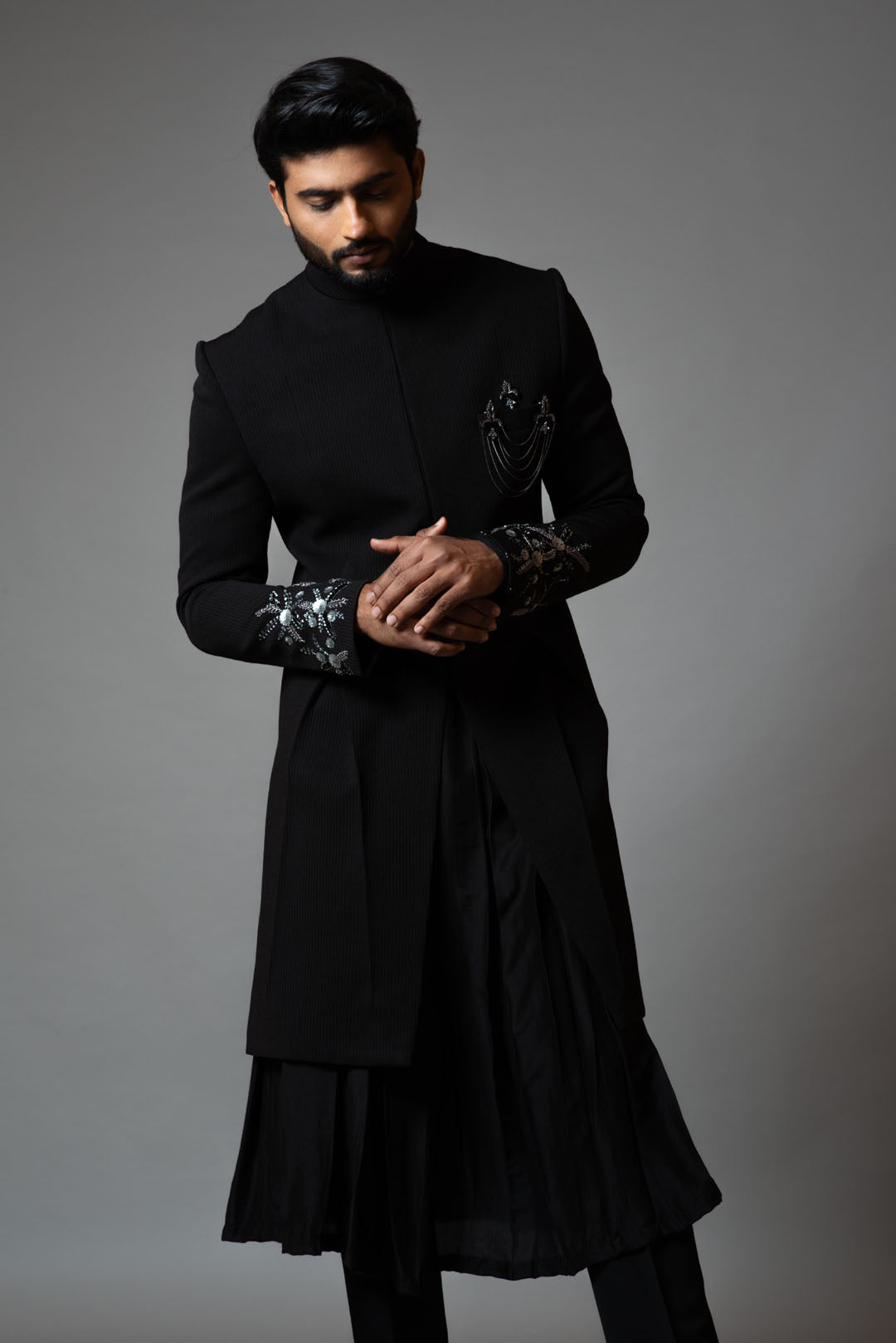 Achkan with slight embroidery on sleeves comes with Anarkali kurta