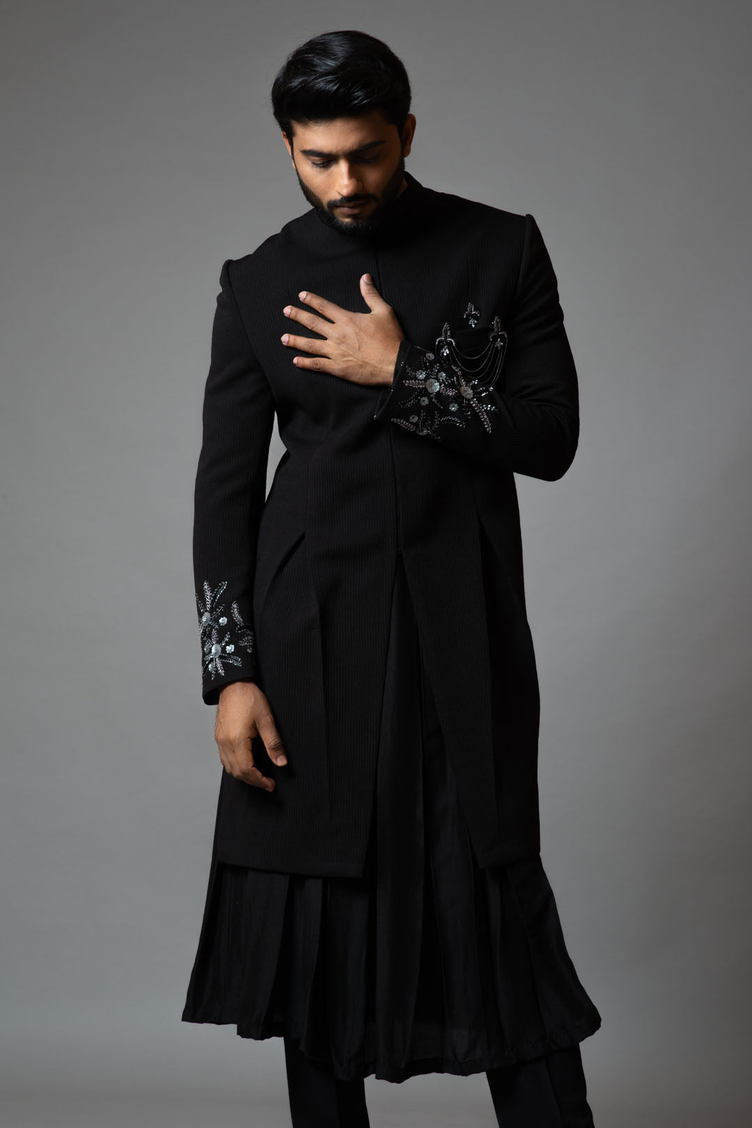 Achkan with slight embroidery on sleeves comes with Anarkali kurta