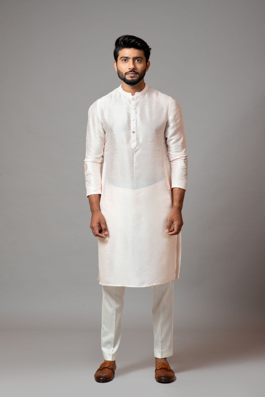 Plain kurta with minimal floral embroidery on sleeves