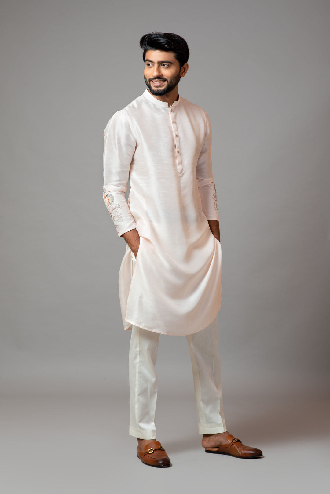 Plain kurta with minimal floral embroidery on sleeves