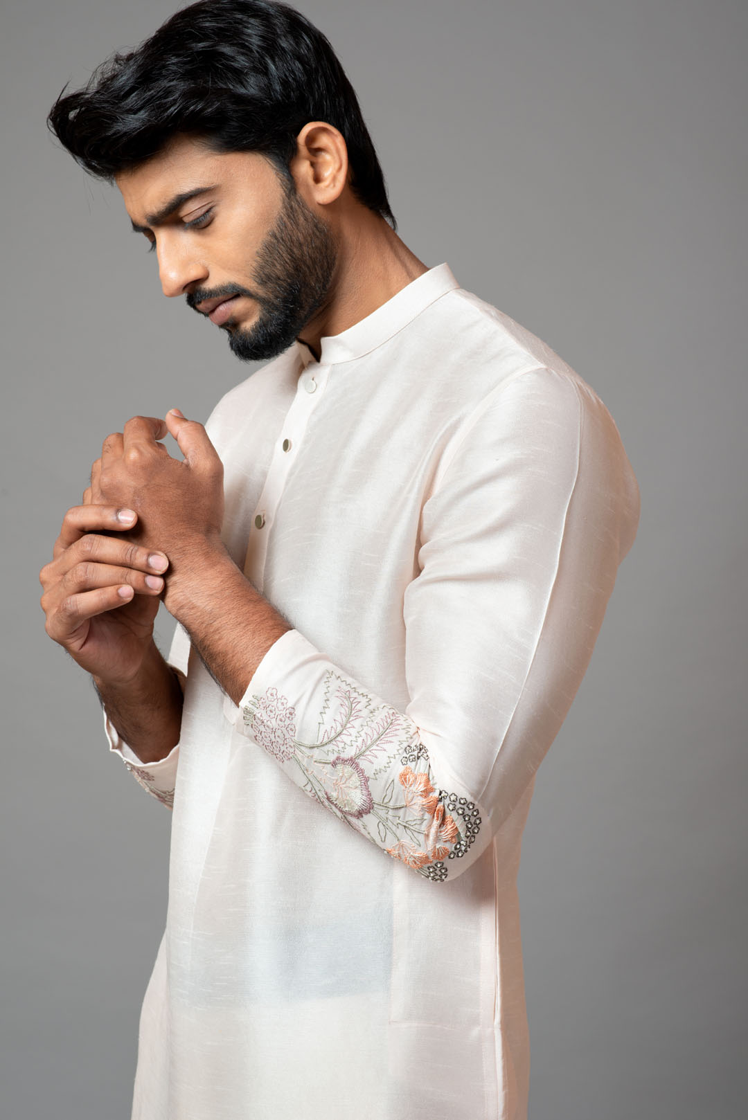 Plain kurta with minimal floral embroidery on sleeves