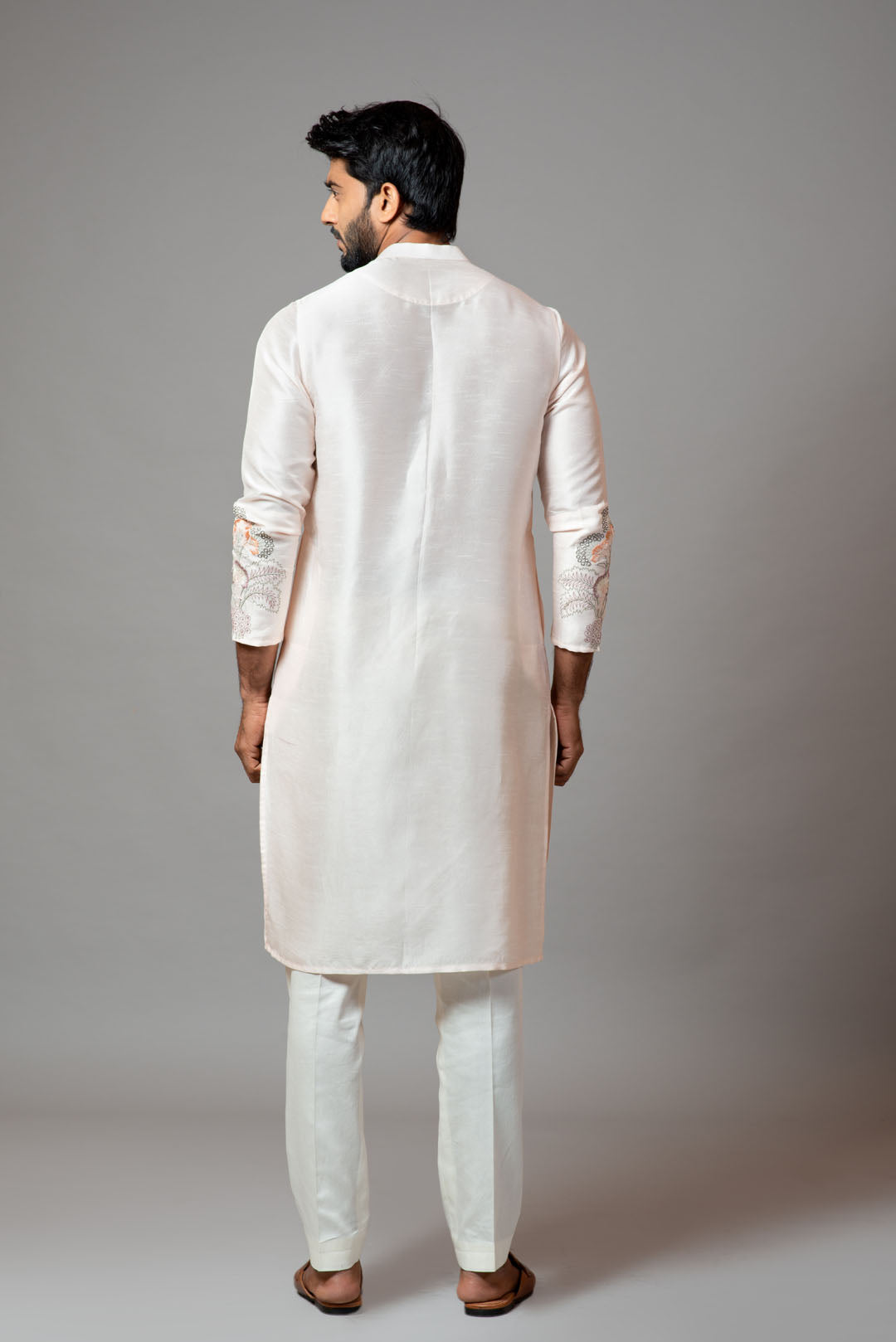 Plain kurta with minimal floral embroidery on sleeves