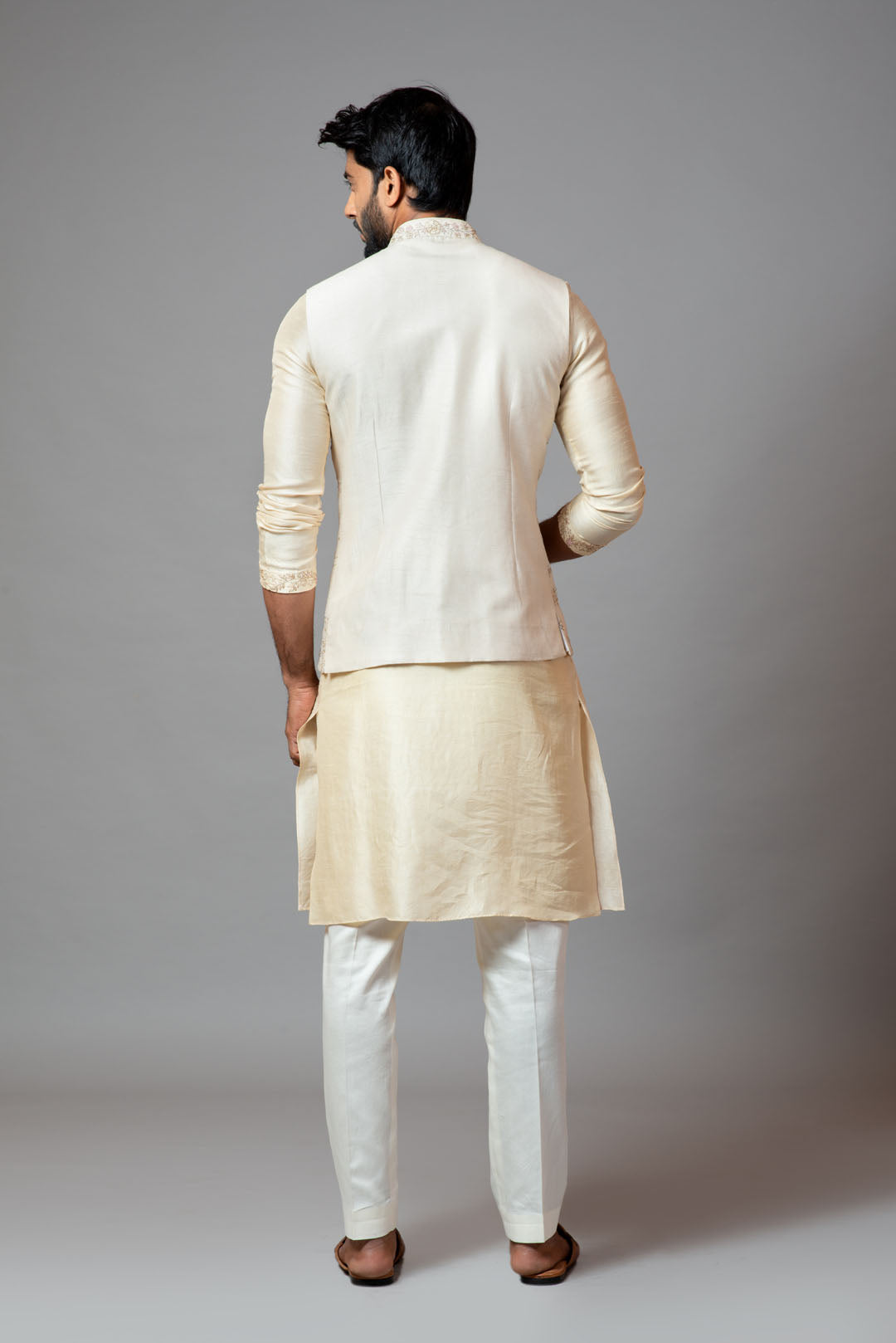 Off white Nehru jacket with delicate jaal embroidery paired with a tonal kurta set