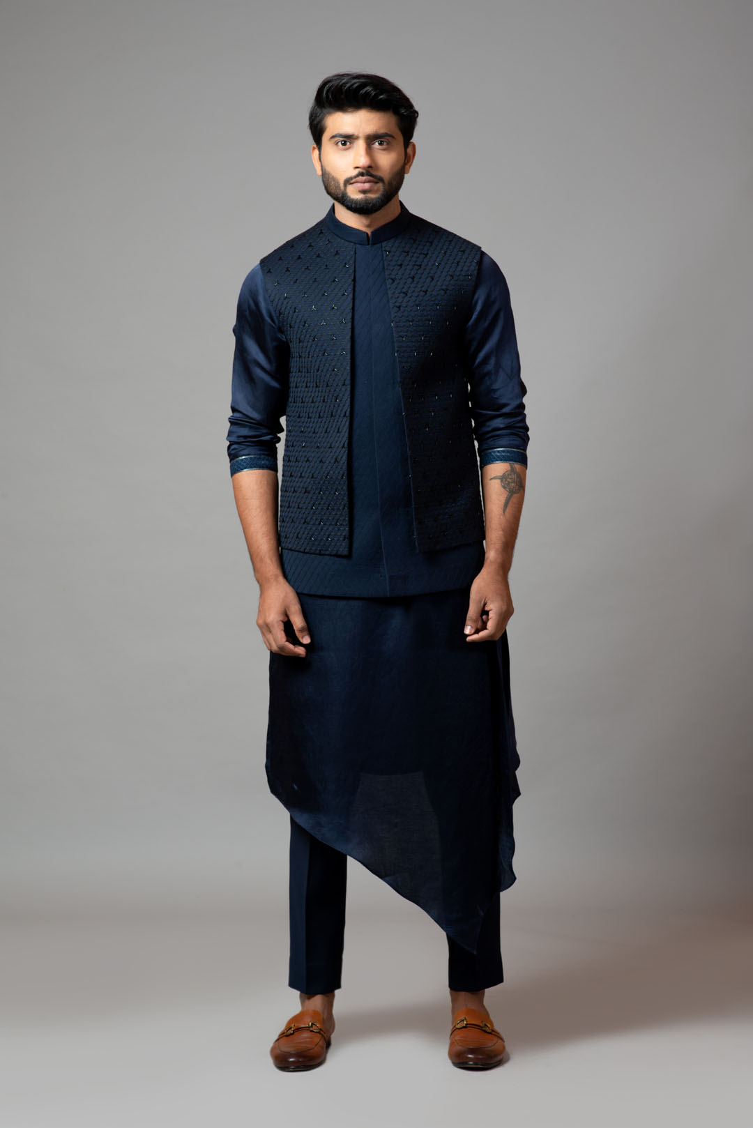 Navy blue Nehru jacket with Honeycomb pattern embroidery highlighted with panel detailing, paired with adrape kurta