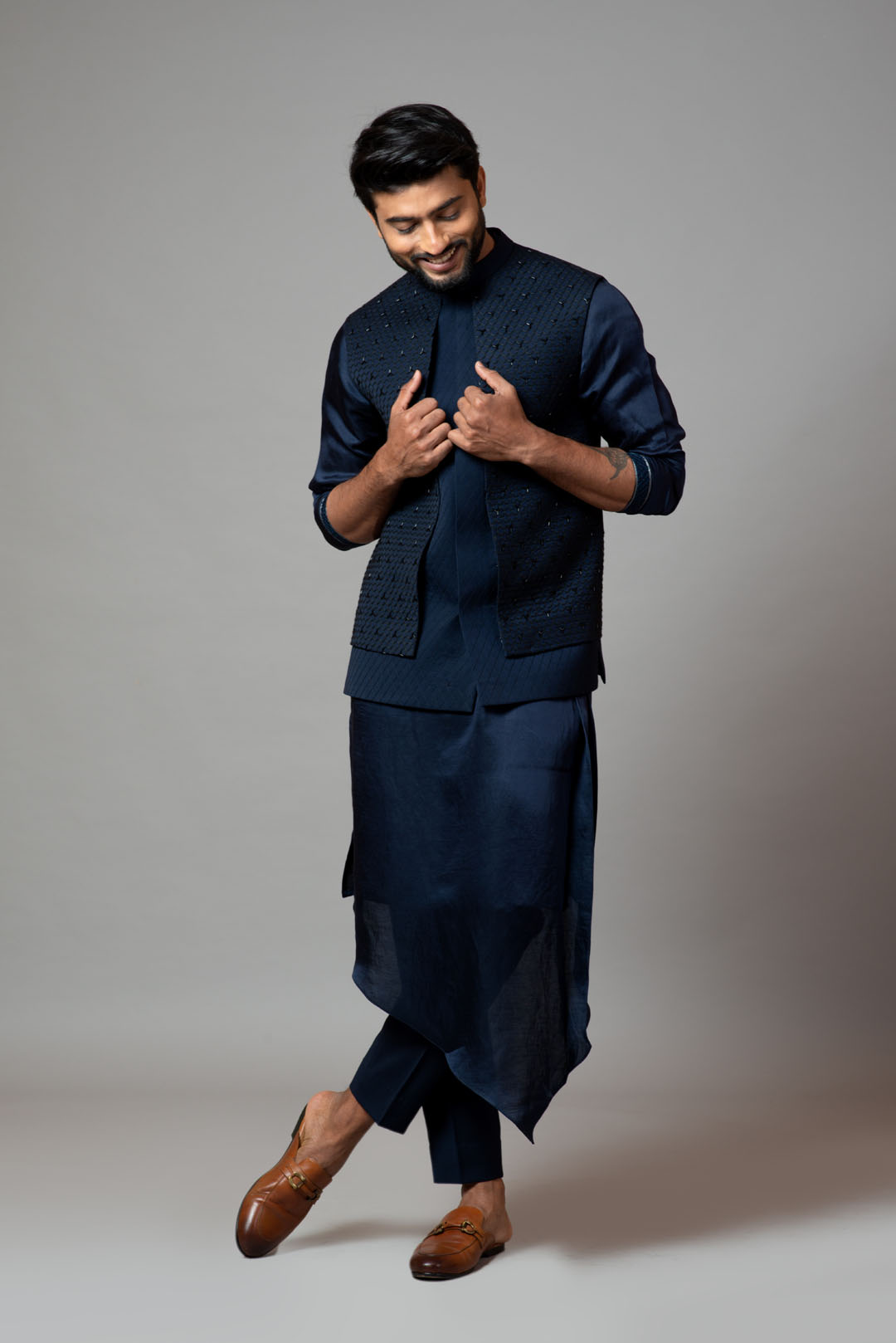 Navy blue Nehru jacket with Honeycomb pattern embroidery highlighted with panel detailing, paired with adrape kurta