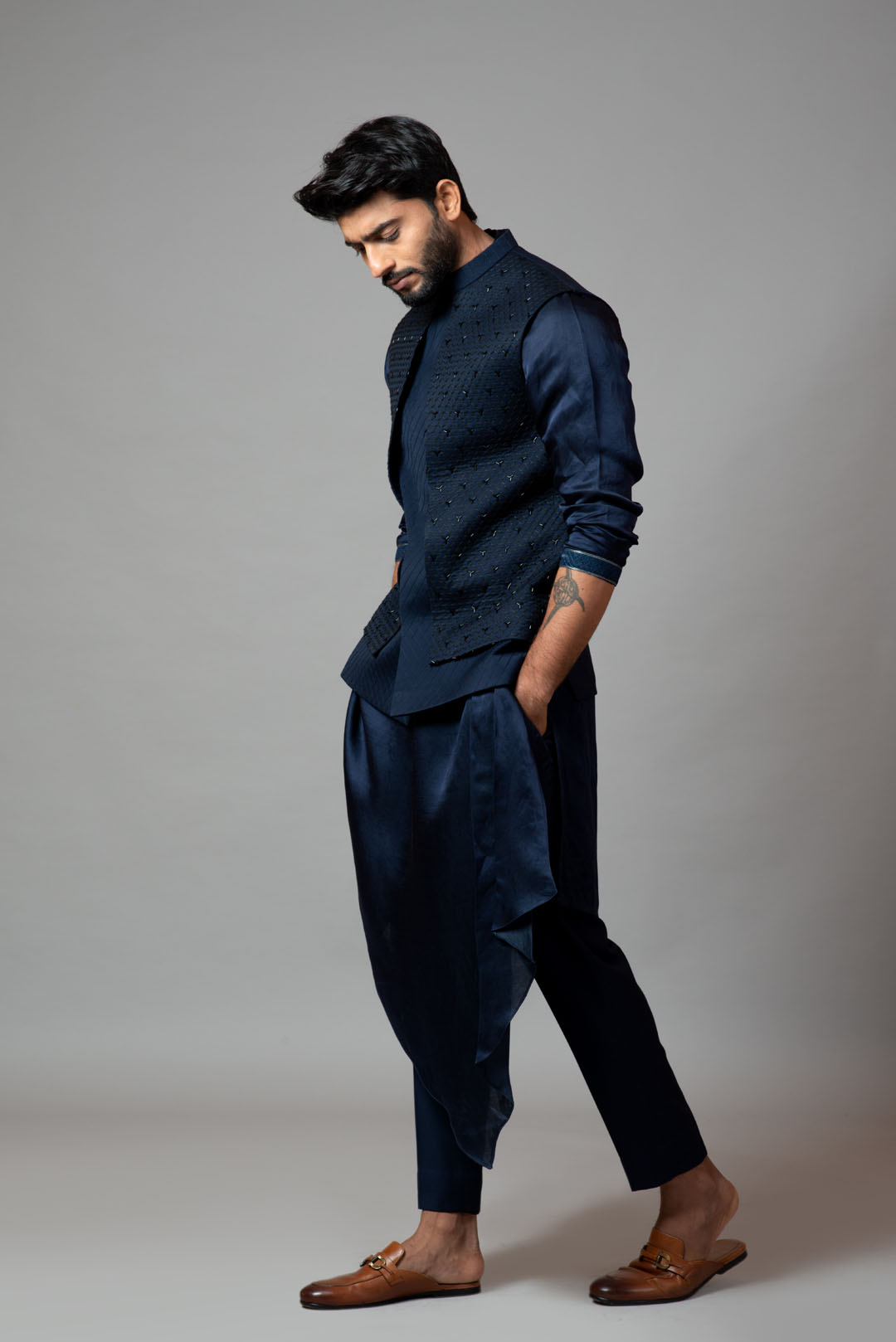 Navy blue Nehru jacket with Honeycomb pattern embroidery highlighted with panel detailing, paired with adrape kurta