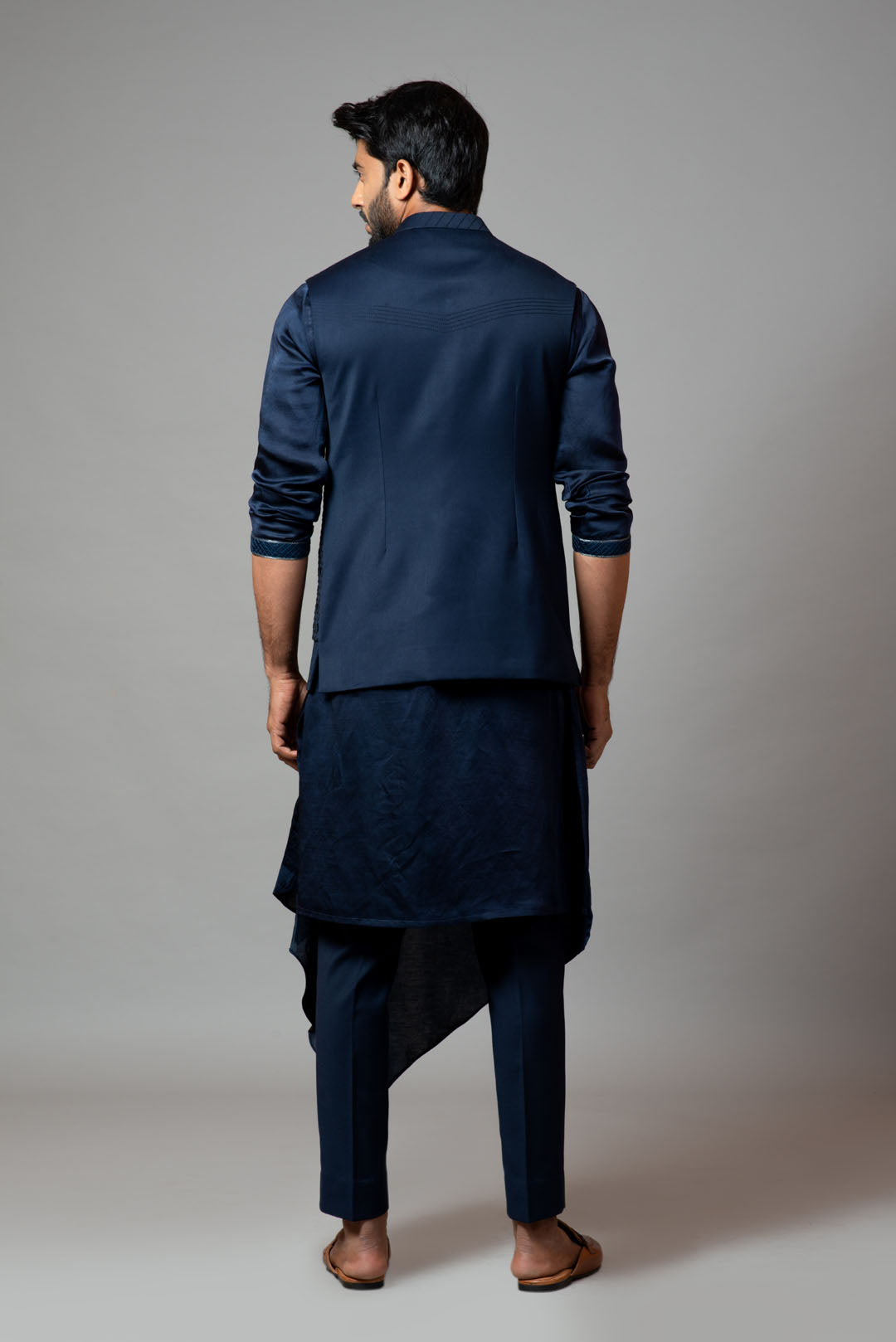 Navy blue Nehru jacket with Honeycomb pattern embroidery highlighted with panel detailing, paired with adrape kurta