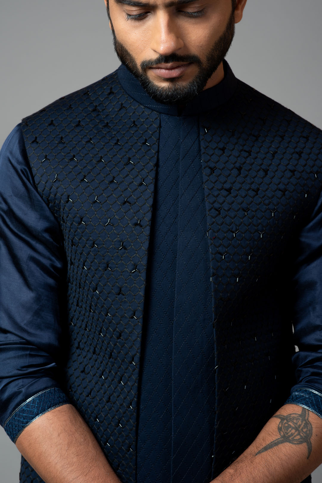 Navy blue Nehru jacket with Honeycomb pattern embroidery highlighted with panel detailing, paired with adrape kurta